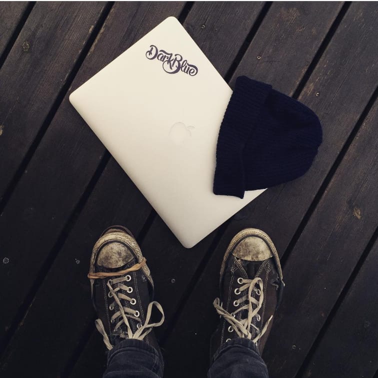 Darkblue branded laptop with Iggy's shoes